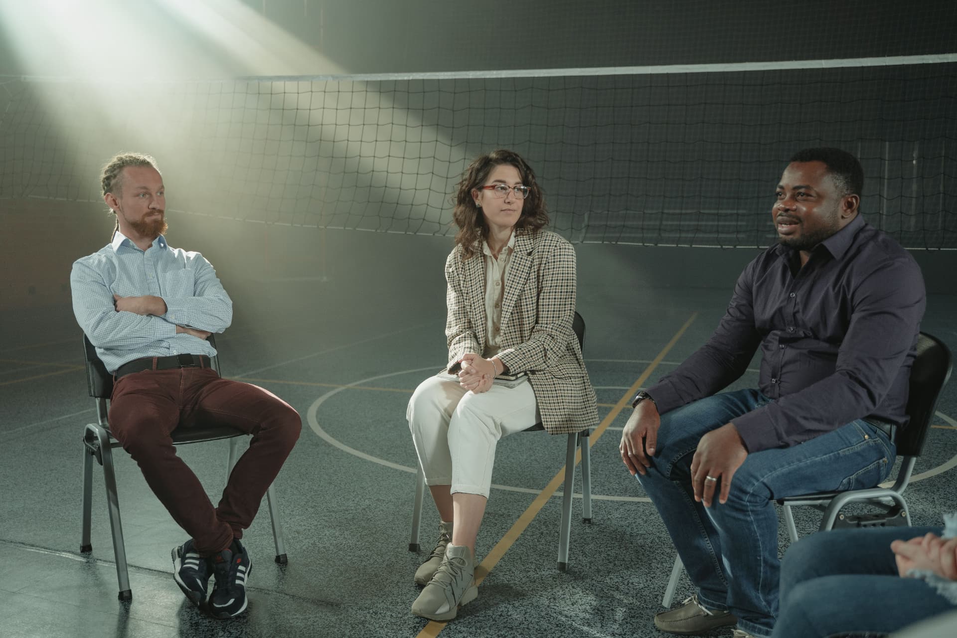 Adults sitting together in a supportive therapy group session
